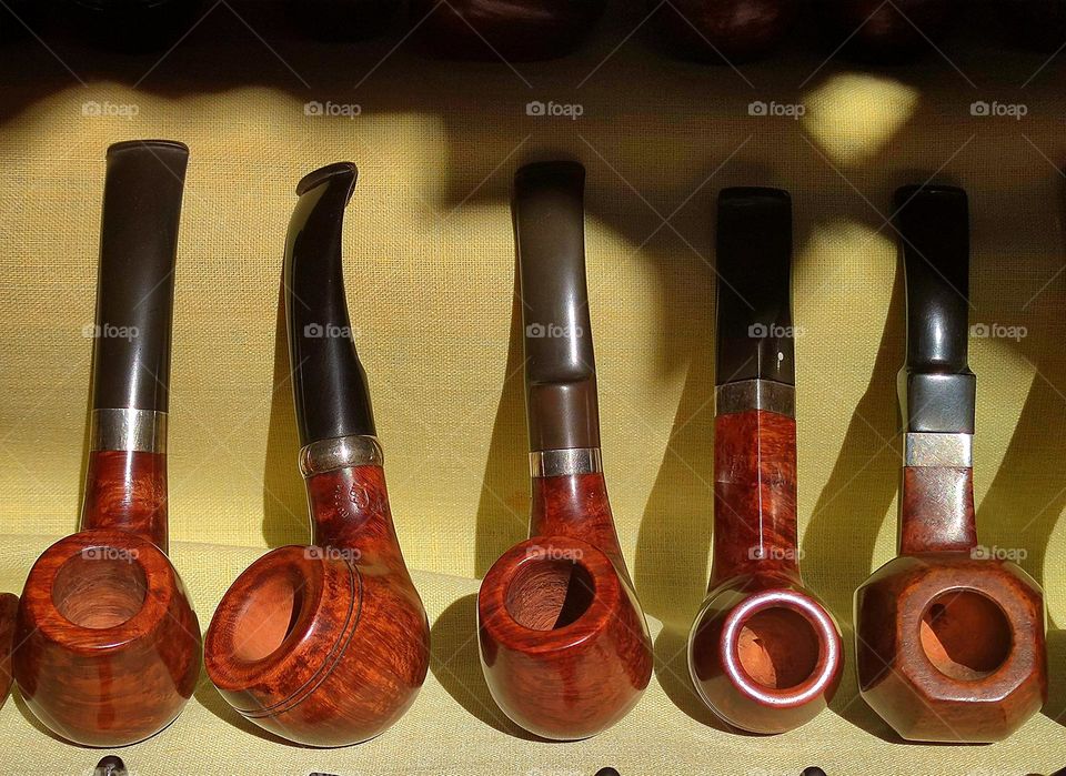 Circles.  Exclusive wooden smoking pipes of various shapes with tobacco chamber circles