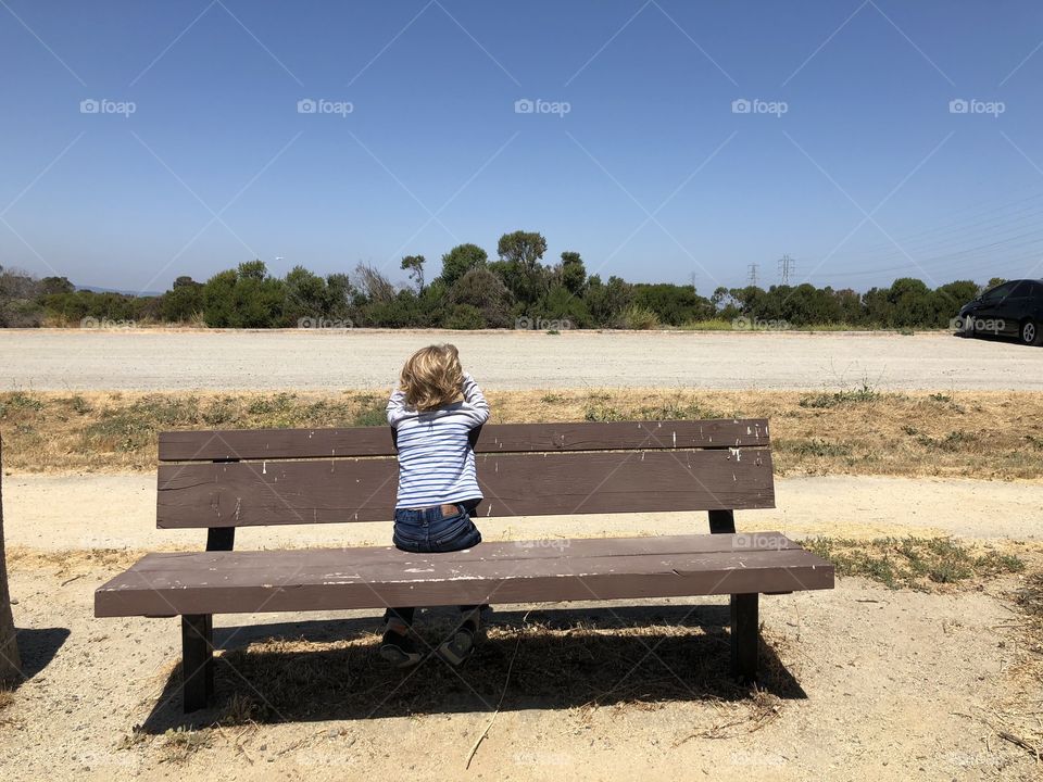 Boy sitting on a bench 