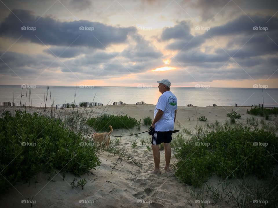 Walking over the sand dunes with sea oats blowing in the breeze. 