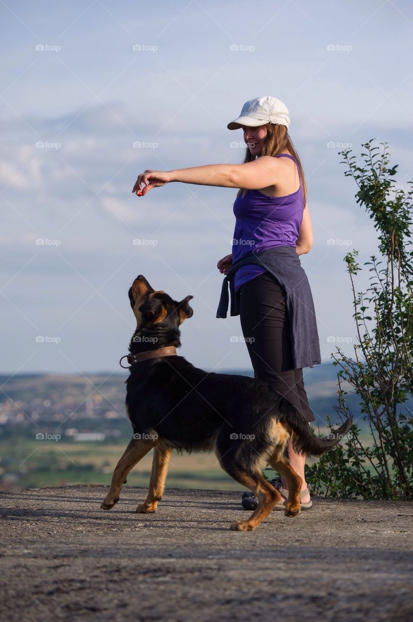 Women playing with her dog in nature
