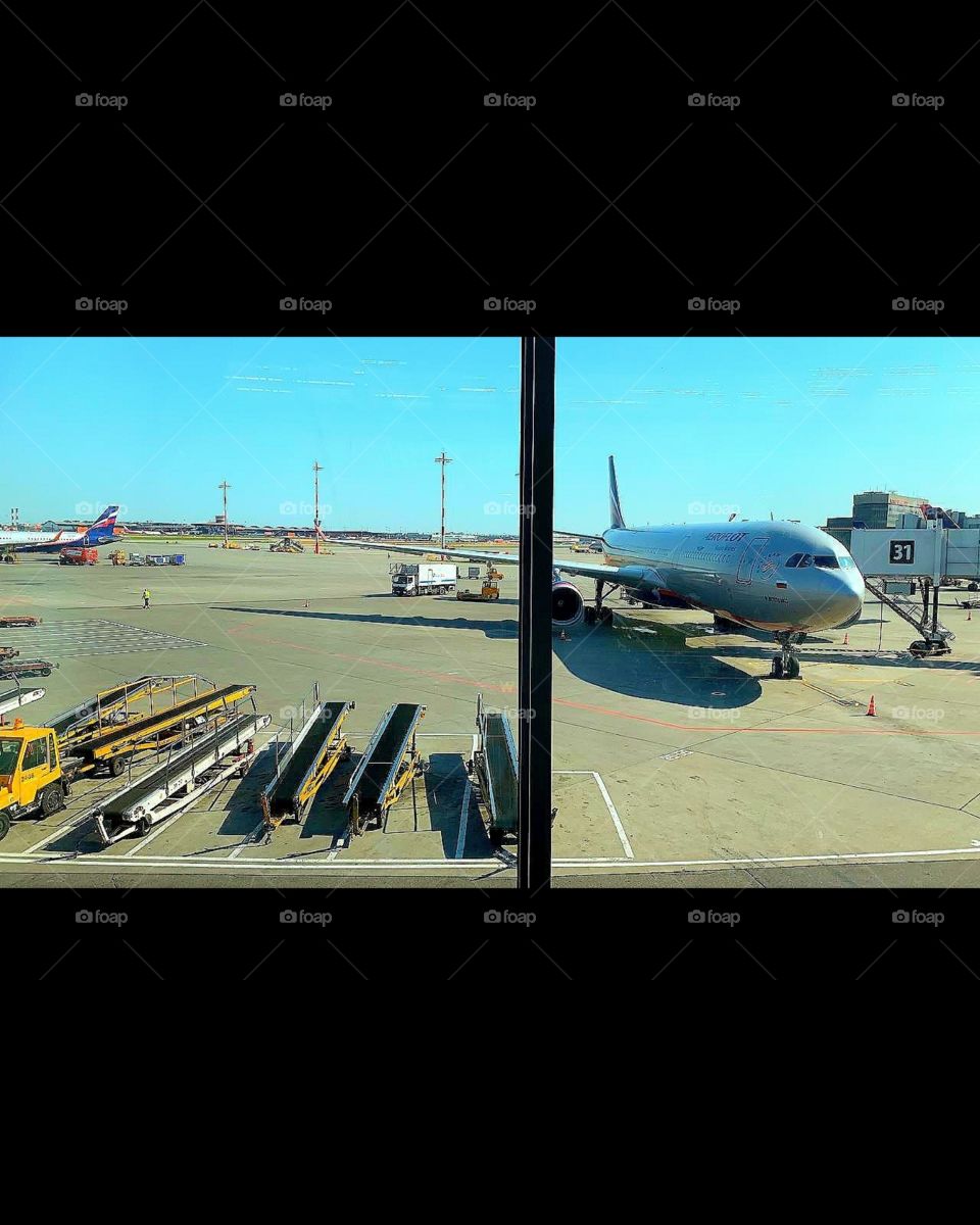 View from the airport window.  Airplanes waiting for passengers