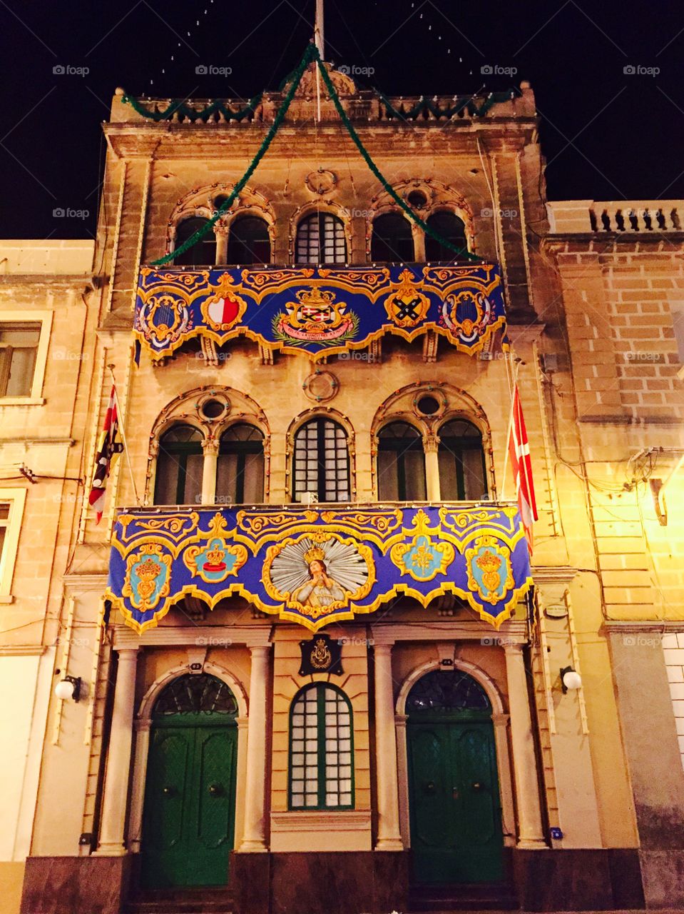 Windows around the world . A decorated house with ornate windows during the feast in L-Isla (Senglea) - in of the Three Cities, Malta.