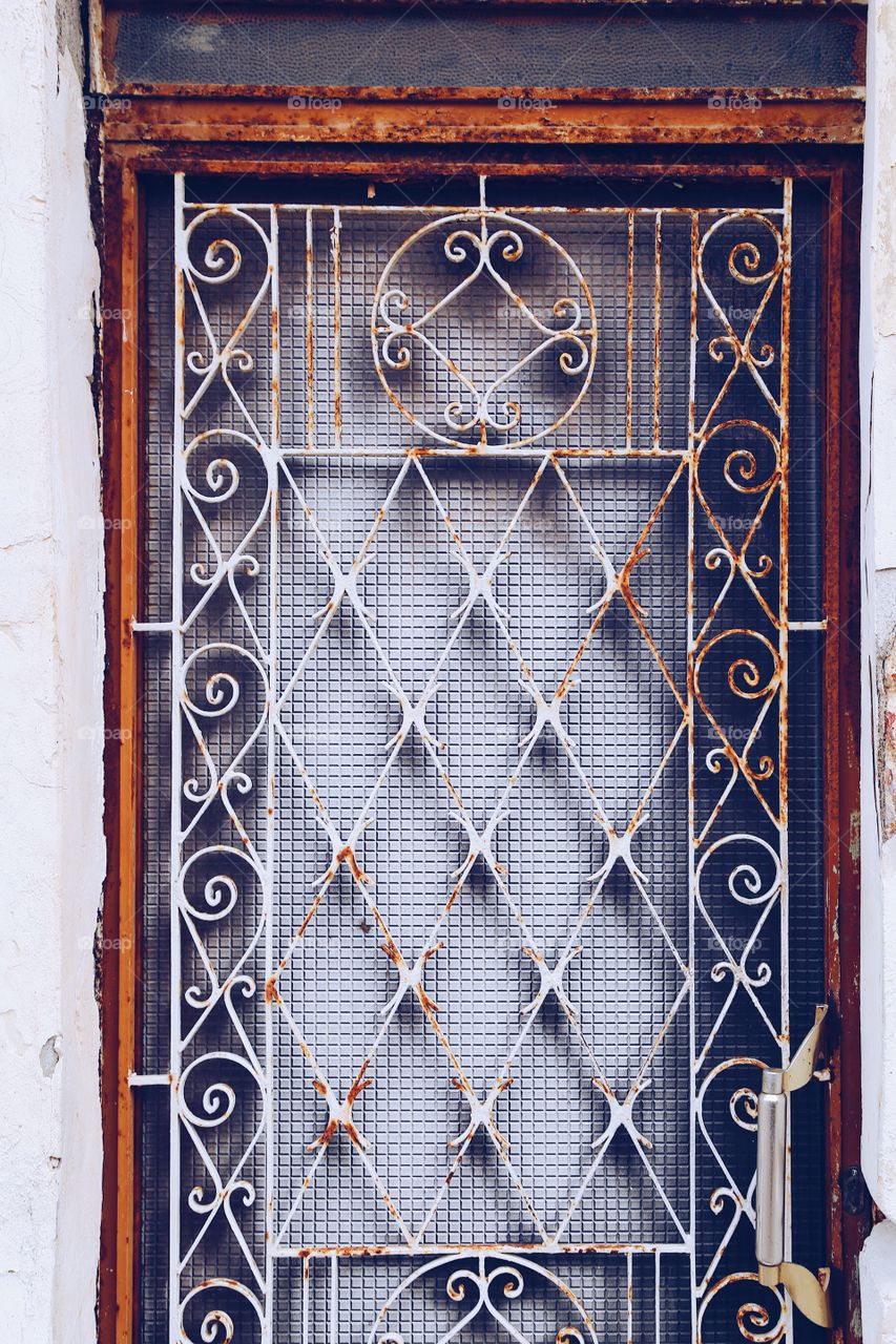 Metal ornament on a door window somewhere in south Europe 