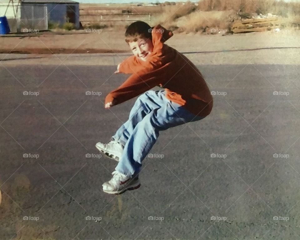 Happy boy jumping in air