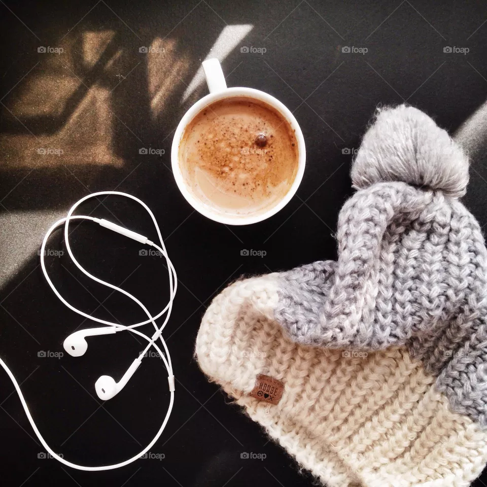 Coffee flat lay, coffee on a black table, winter coffee, winter hat, bubo, hat with bubo, warm stuff, things to keep warm, apple headphones