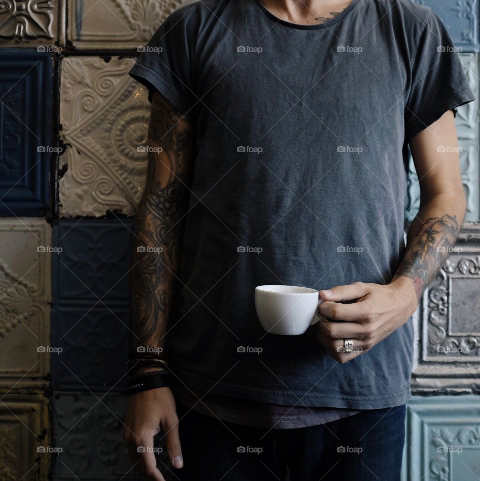 This is me holding a cappuccino in the late afternoon light, against a really colorful wall. 