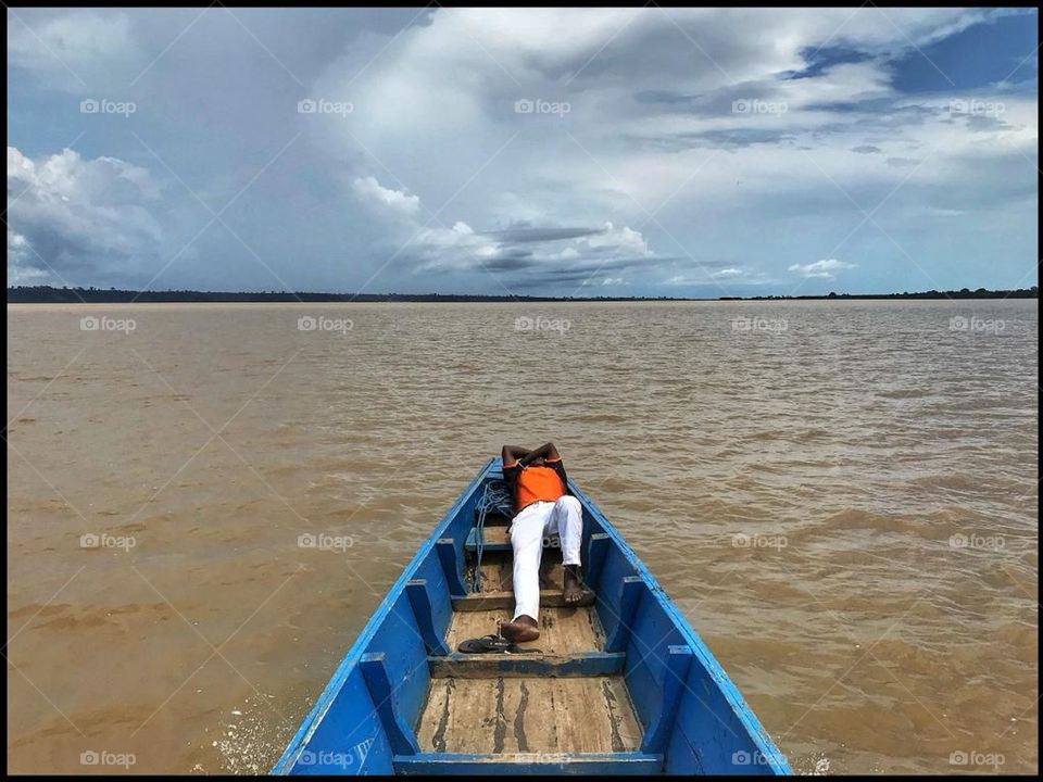 Boat ride in Abidjan, Africa. 
Young men having some rest.