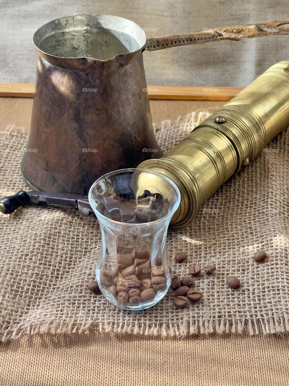 Coffee beans and old coffee grinder and copper pot