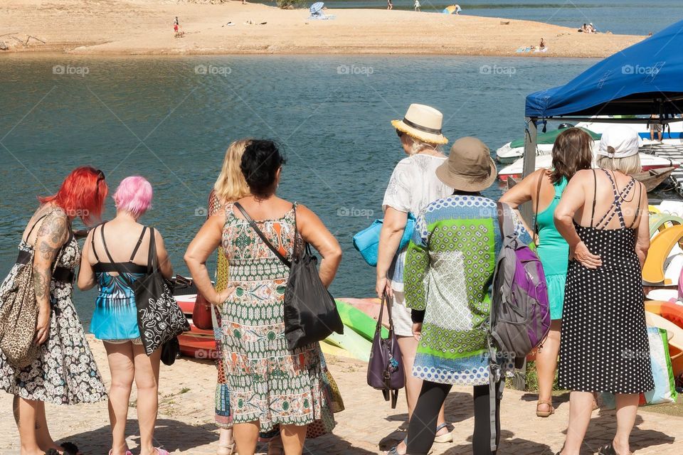 Group of women arrive at the river for a swim