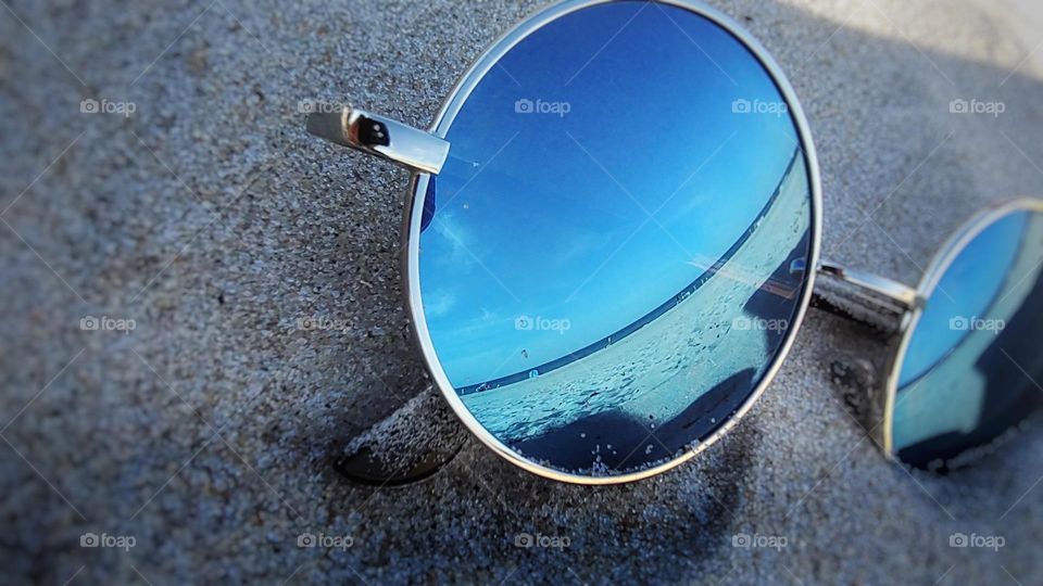 glasses lying on the sand