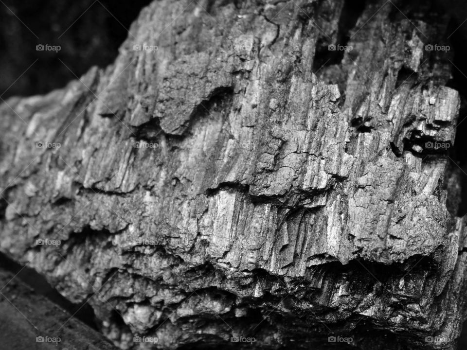 Textured black charcoal block close up angle view