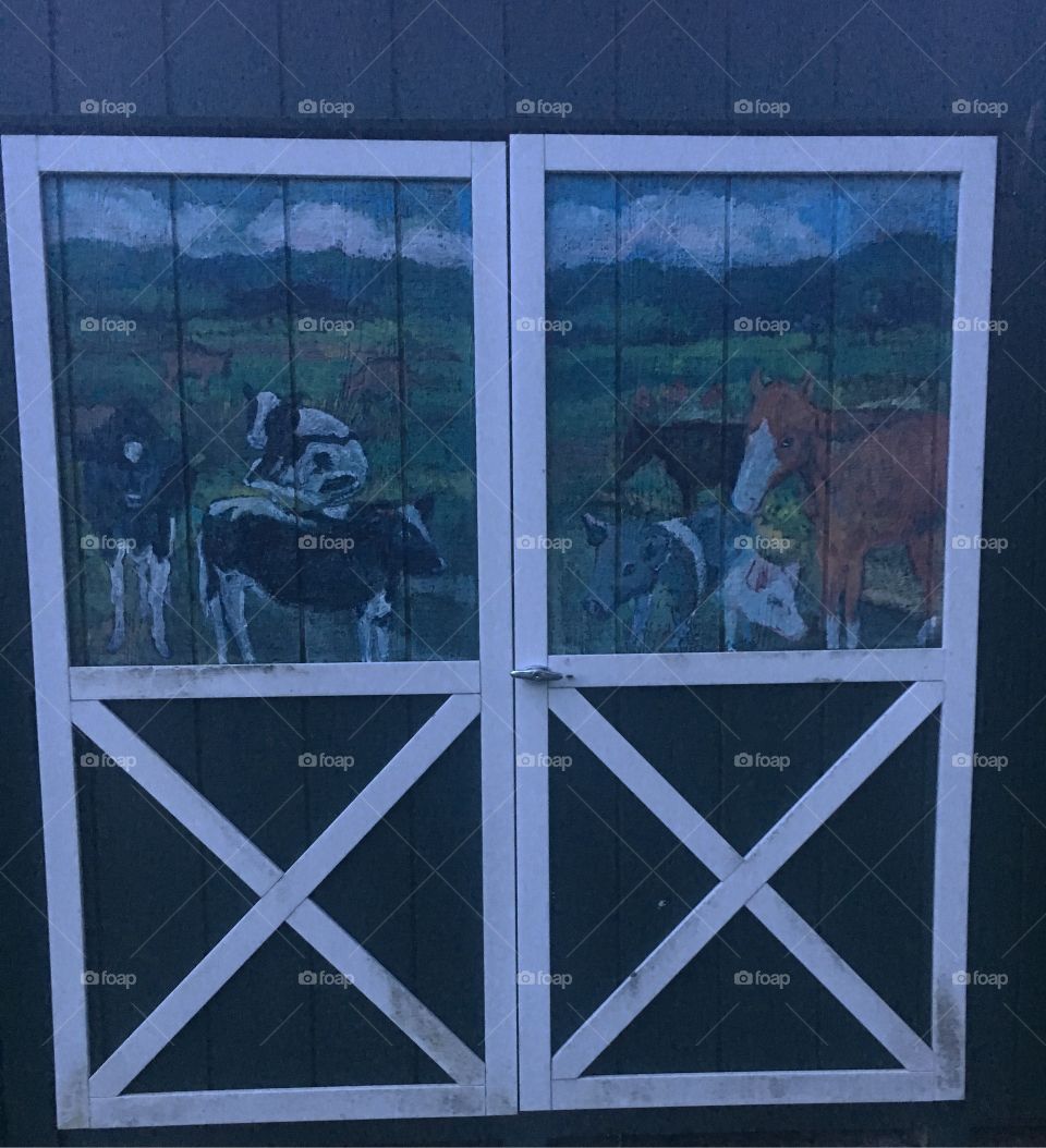 A farm painting on a barn at night