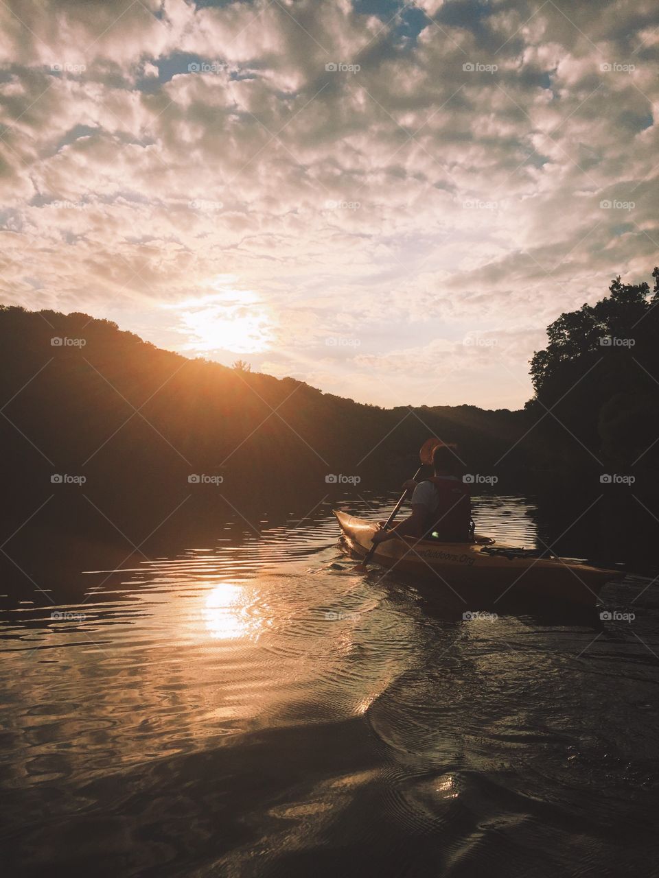 Kayak sunset. Catching those golden rays on the lake as the sun recedes into the hills