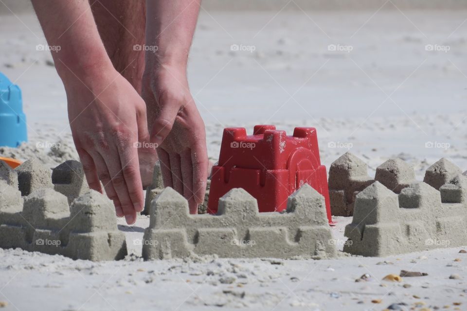 Building a Sand Castle at the Beach. Sandcastle Building on a Warm Florida Beach.