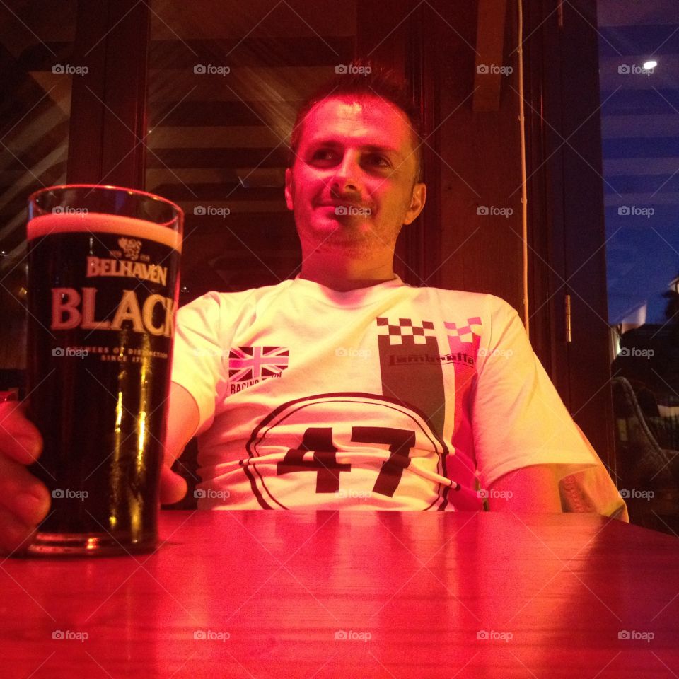 boy drinking black beer. black beer crawley pub