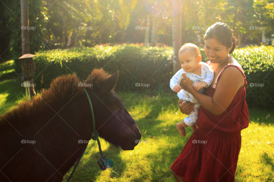 Mother and son at the ranch. Mimi holding Thithi on a sunny day