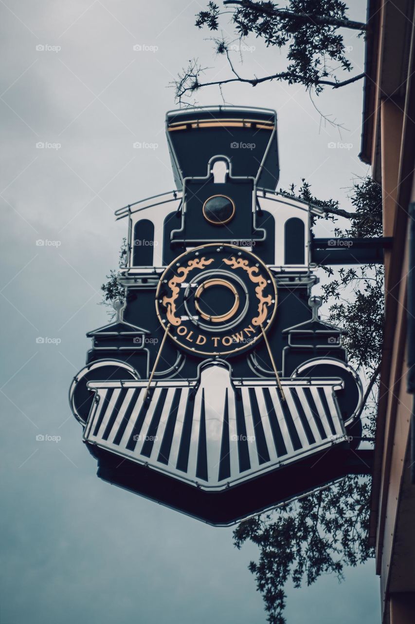 Vintage Retro Old Town Locomotive Train Sign looking up with sky background