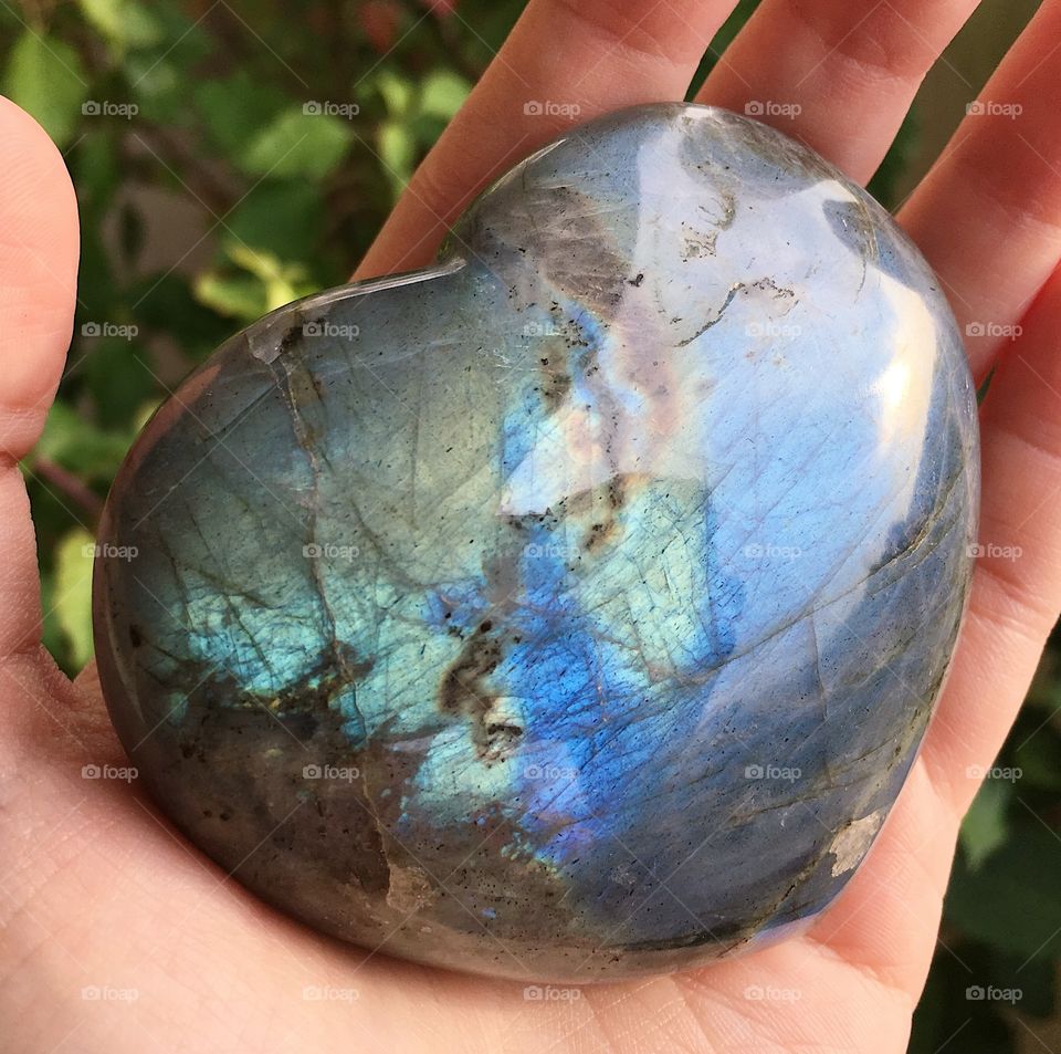 A heart-shaped labradorite mineral stone.