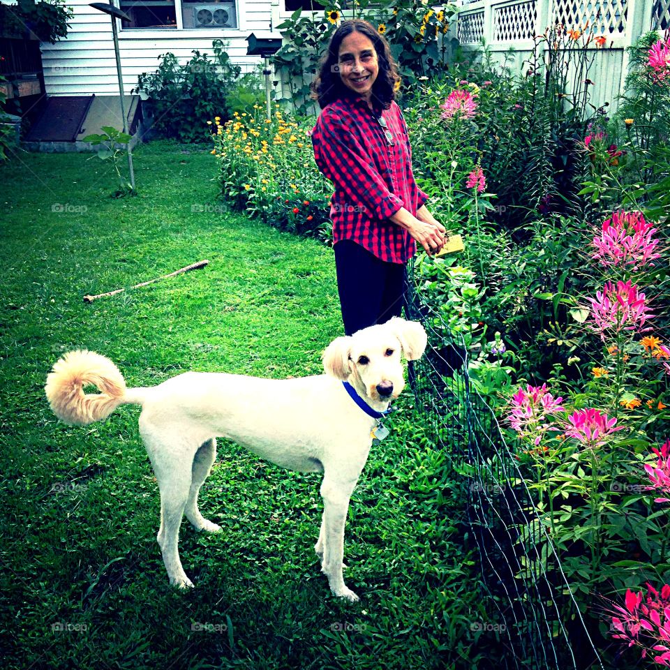 Mature woman with dog in the garden