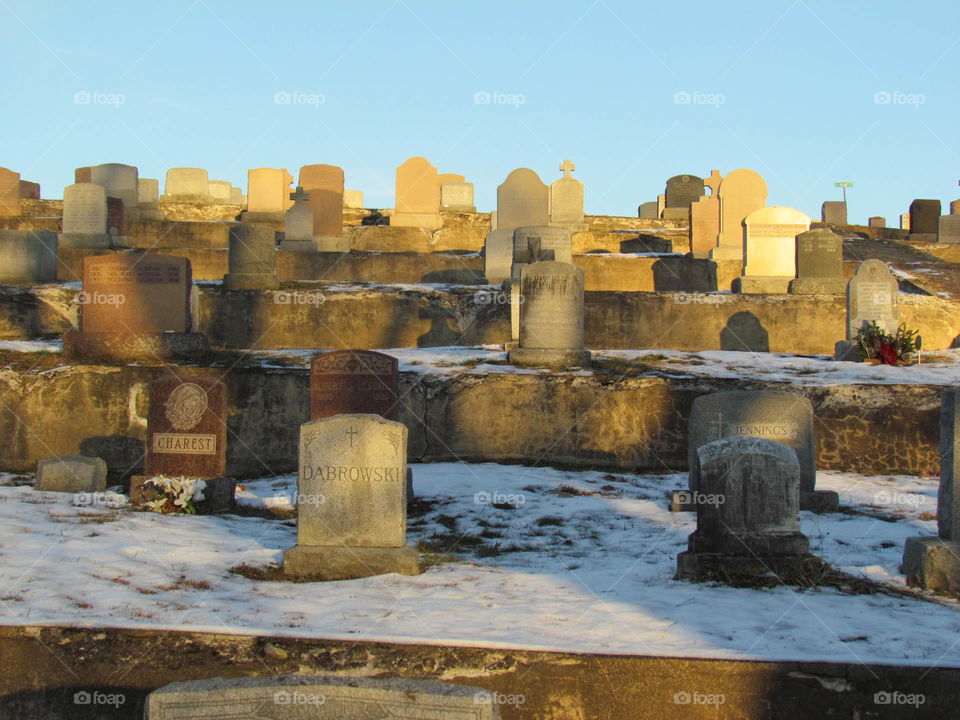 Tombstones in cemetery in winter