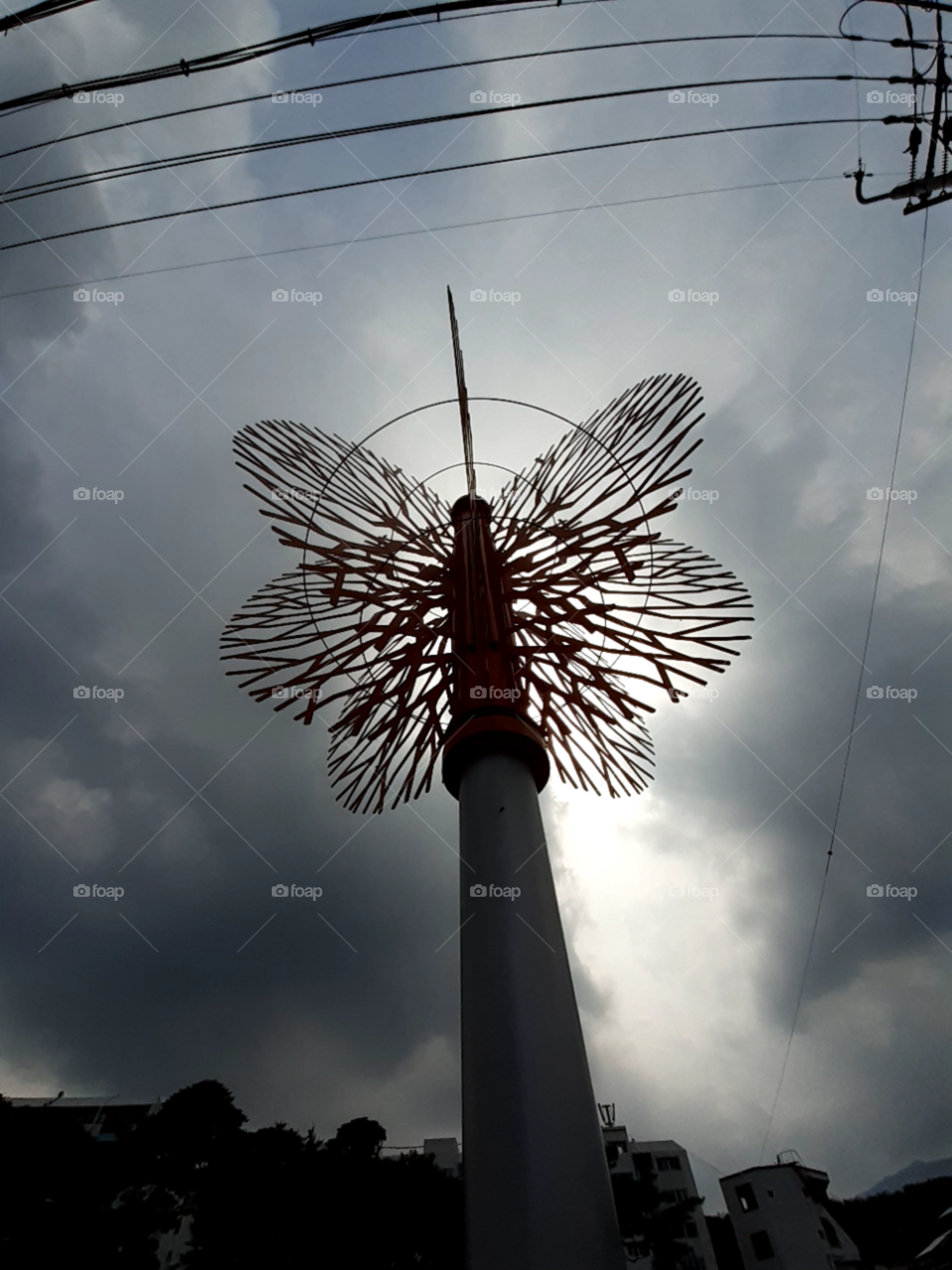 the street decoration tower shadow.  thanks to the light from the sky.