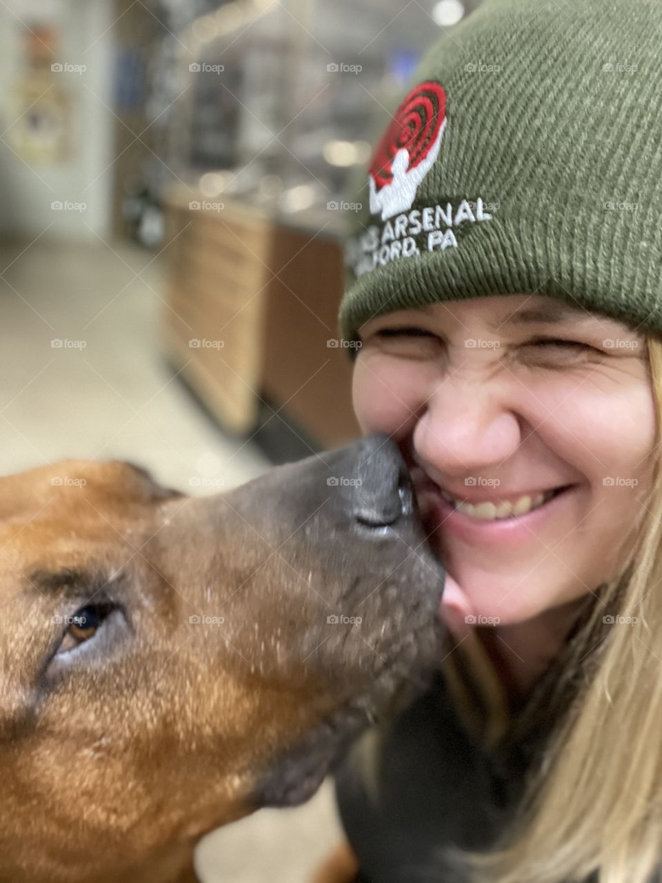 The best Shop Dog around; Mastiff Mix liking a young woman’s face in a local small business
