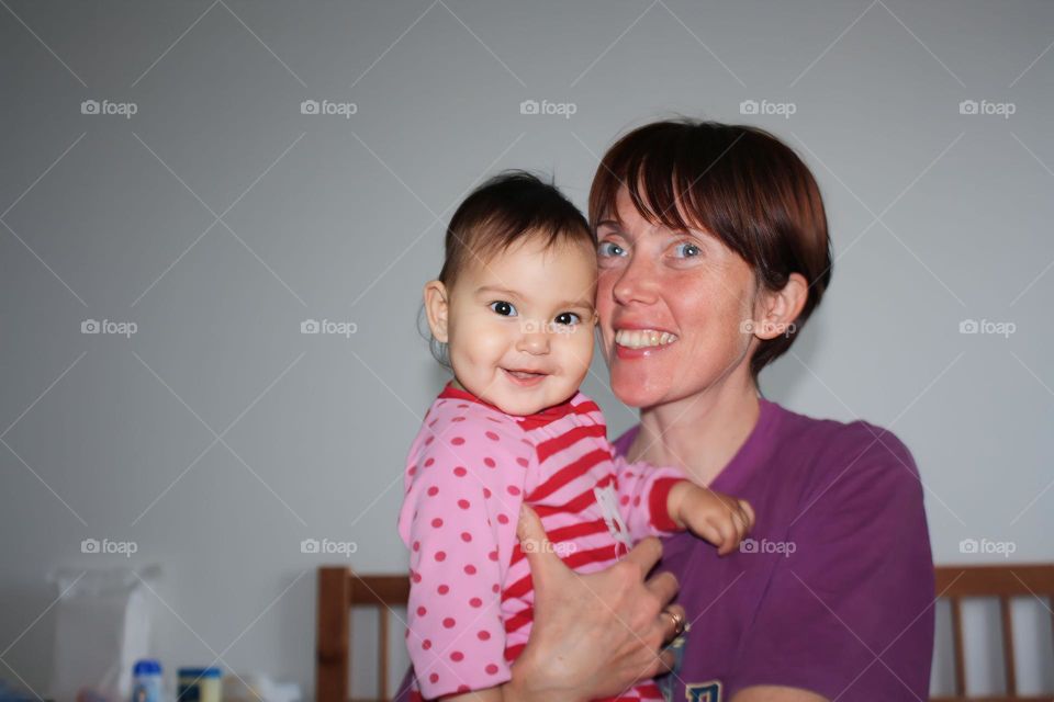 Happy young mother and her cute baby girl