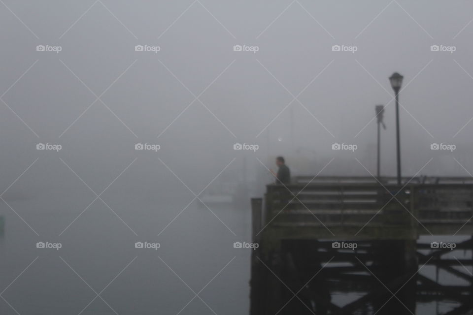 Fisherman in Portsmouth NH on a foggy day. 