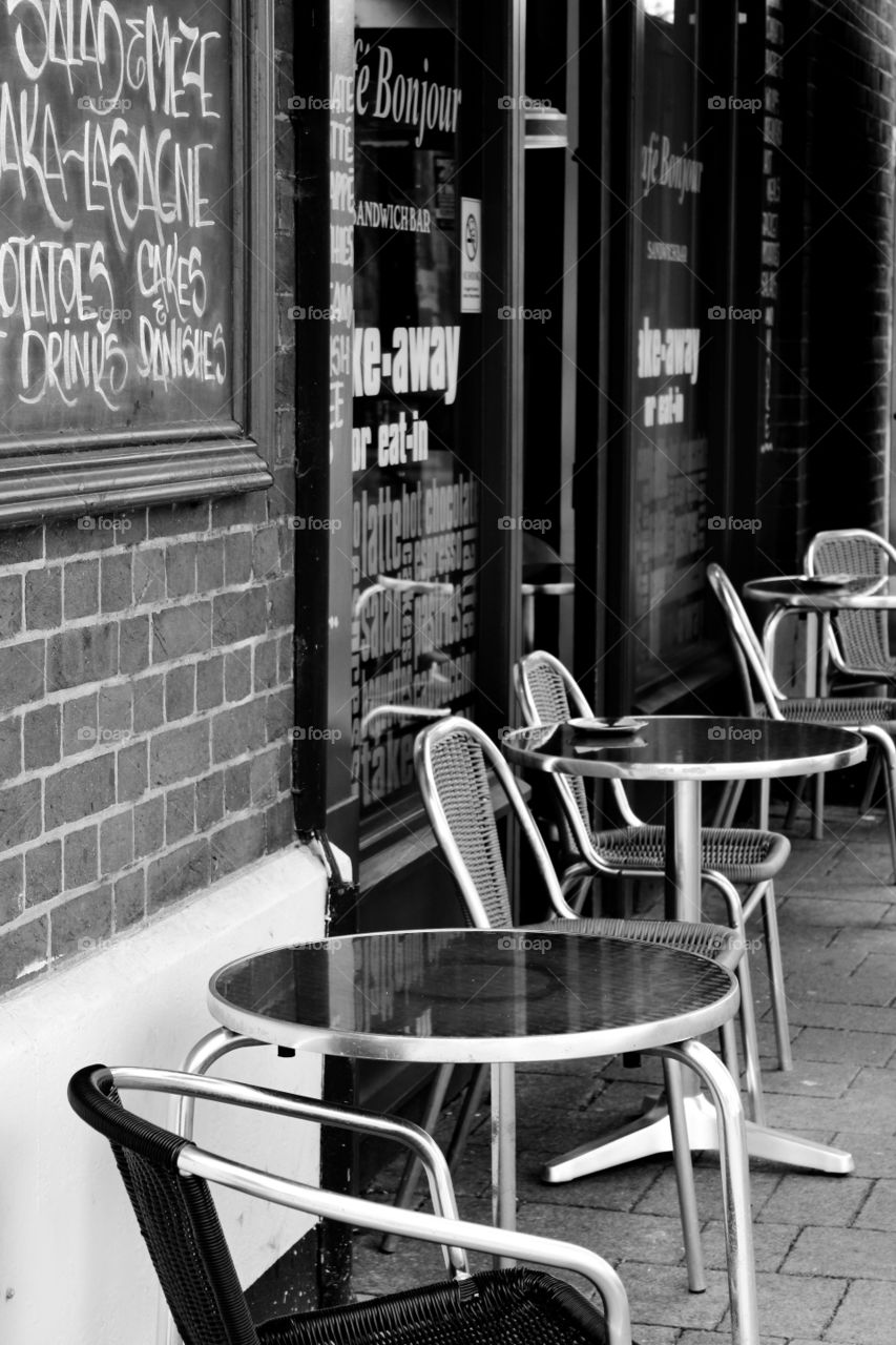 A timeless black and white photo of the seating outside of a cafe in Headington, Oxford.