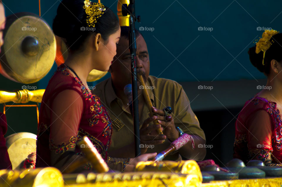 Side view of woman playing music instrument