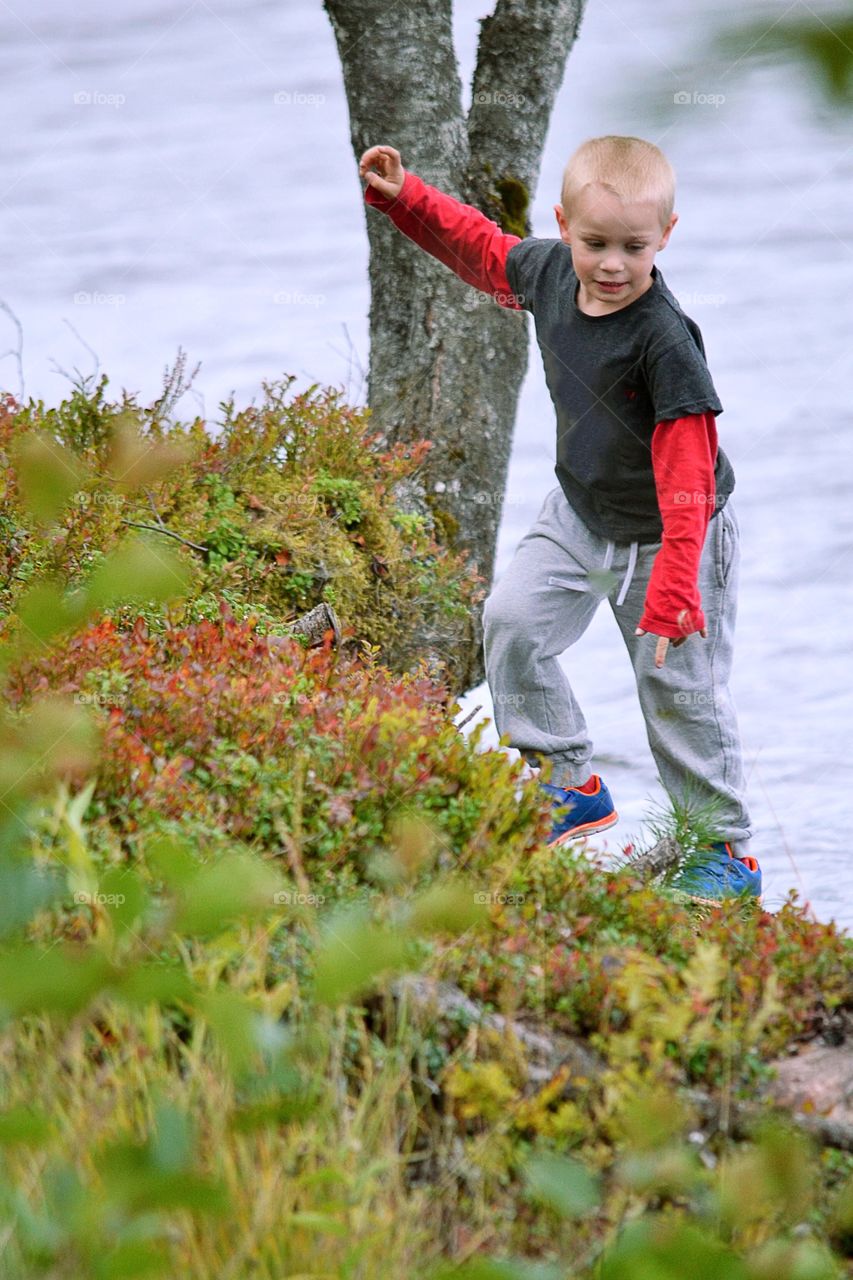 Boy climbing in the nature