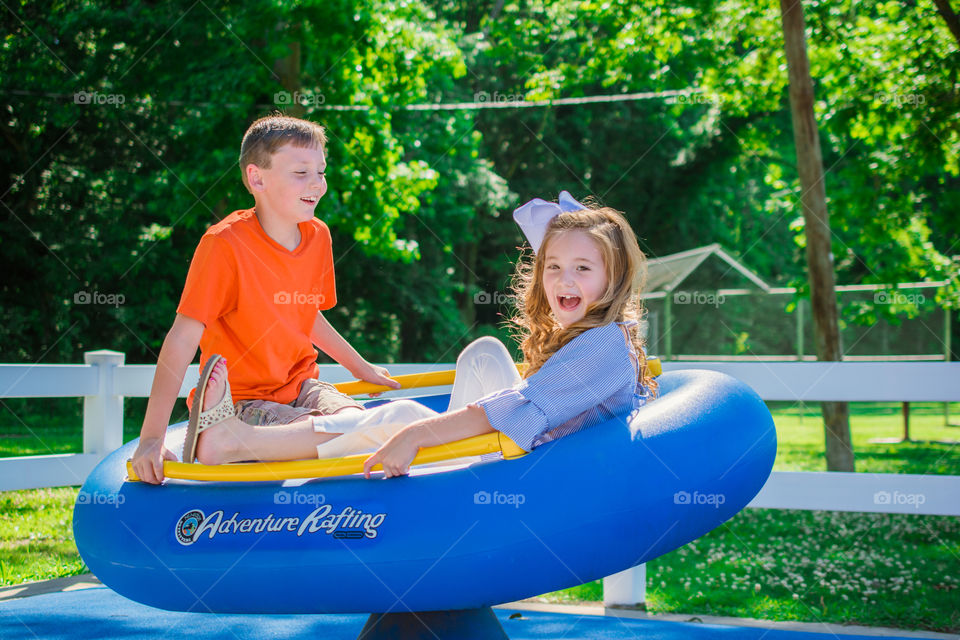 Young Boy and Young Girl Playing at the Park