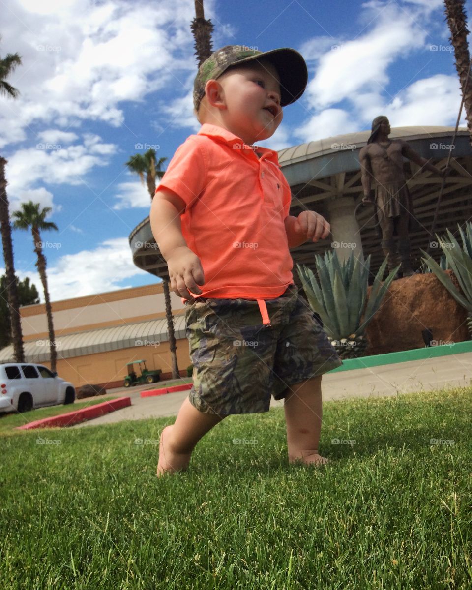 Low angle view of a boy walking in grass