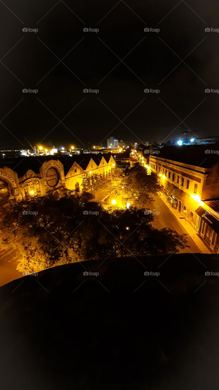 the view of a ninja at night on top of the roof of a building