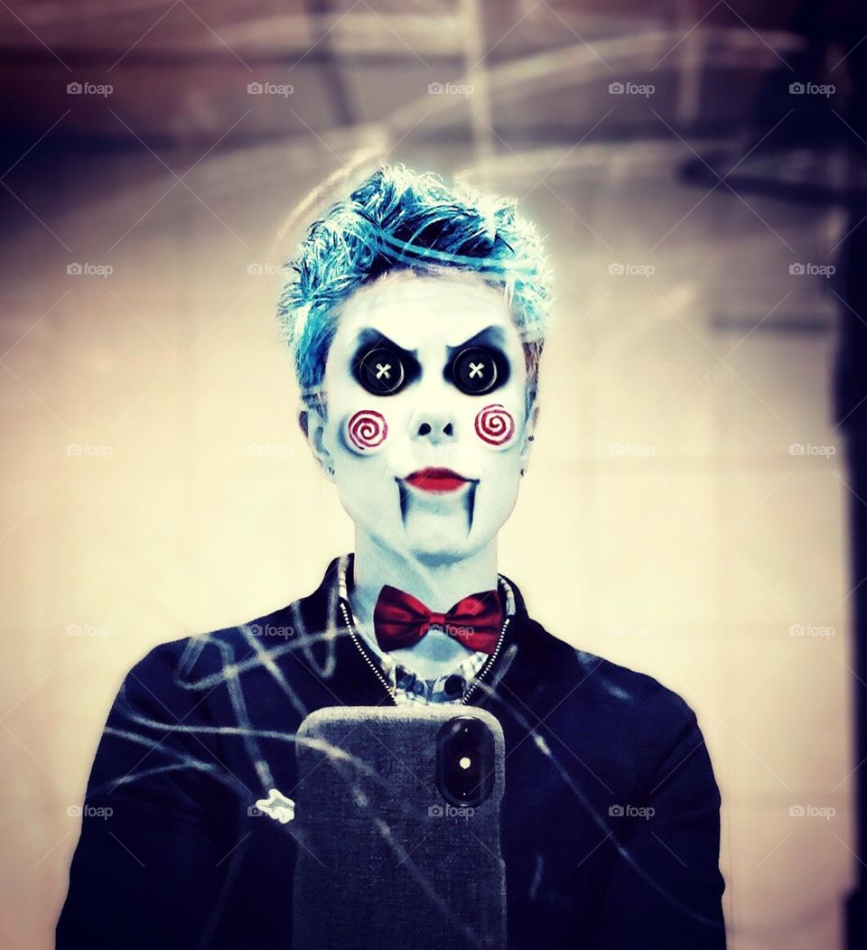 Spooky woman dressed as clown, spooky costumes from Halloween, woman dressed as character from Saw movies, creepy Halloween costumes, scary Halloween costumes