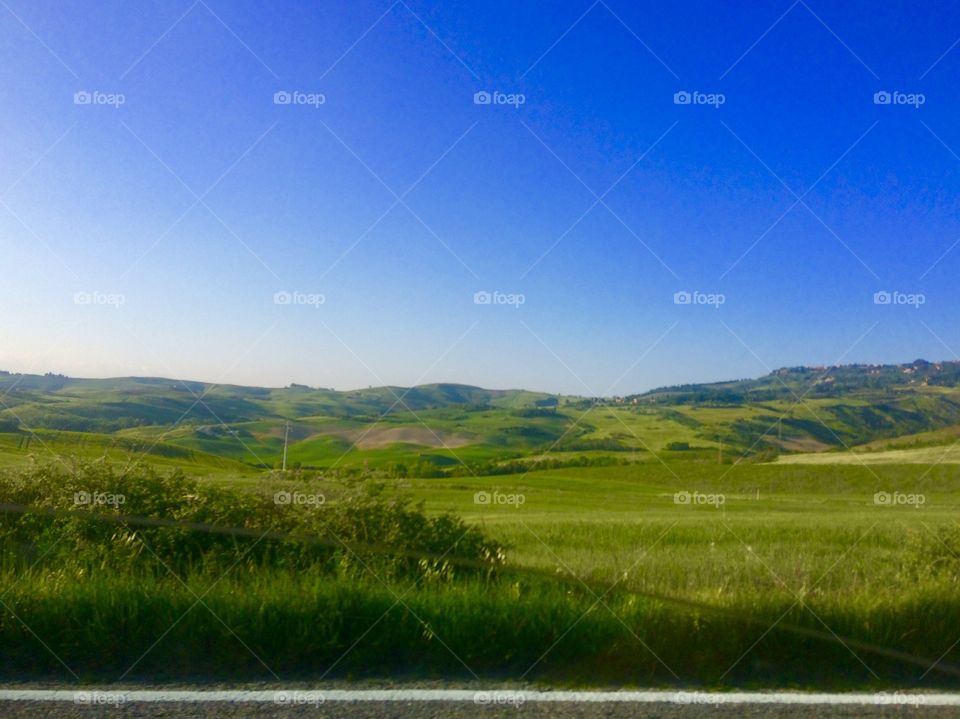 Tuscany hills, countryside landscape, green field, roadside view