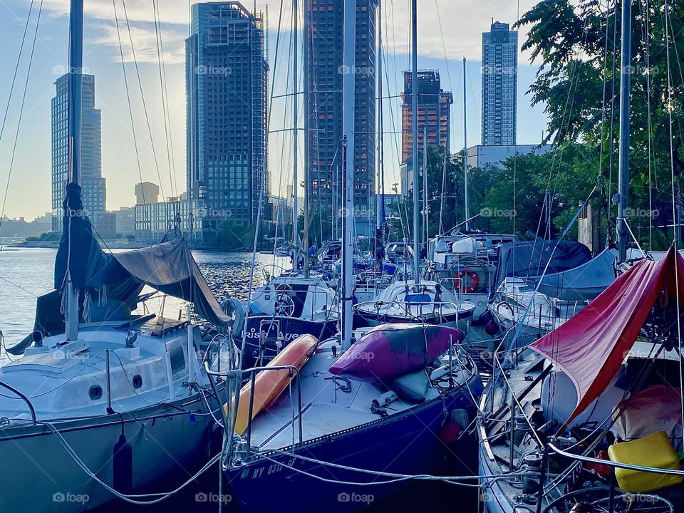 These boats are tied to the shore at “Newtown Creek” by the “Pulaski Bridge” in LIC, Queens on a warm balmy Indian summer evening in September 2023. Hypnotic Productions