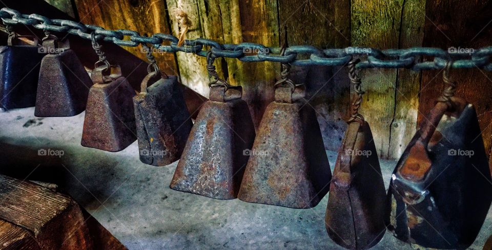 Rusty old cowbells on a chain—taken in Ludington, Michigan 