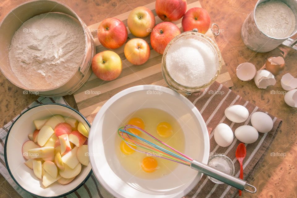 Making homemade puffed apple pie with eggs, sugar and flour.