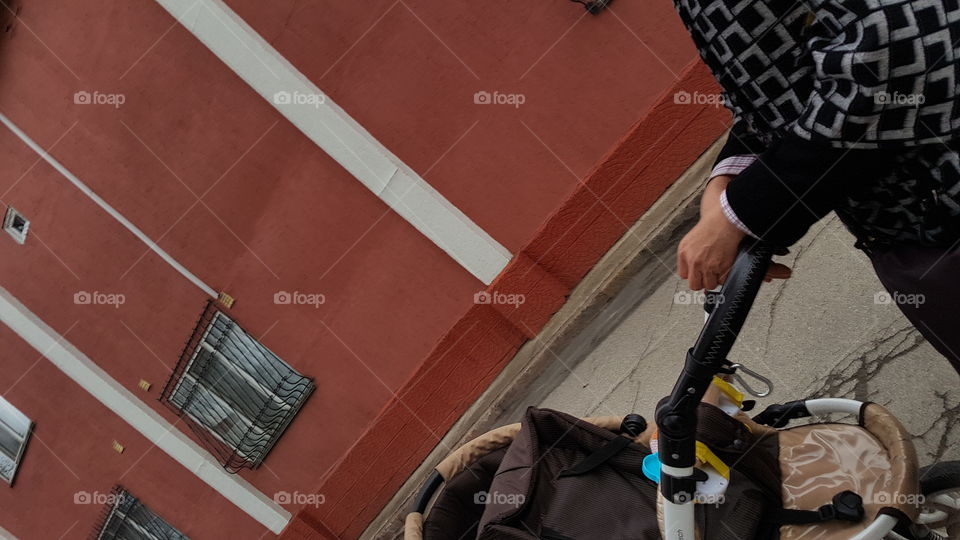 driving stroller against red wall