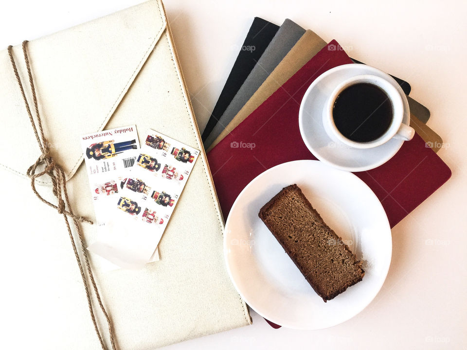 Bright desktop flat lay with coffee and bread cake