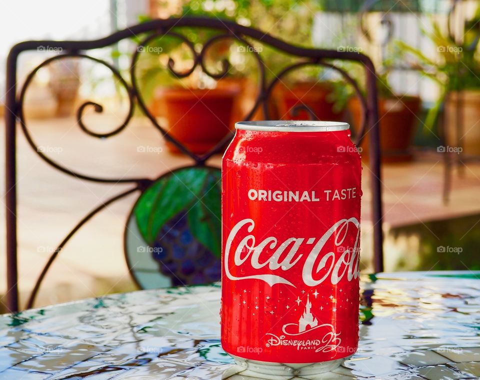 Coca cola can on garden table.