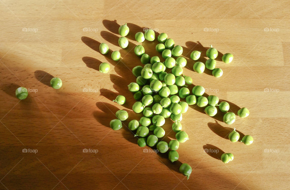 Fresh green garden peas in sunlight