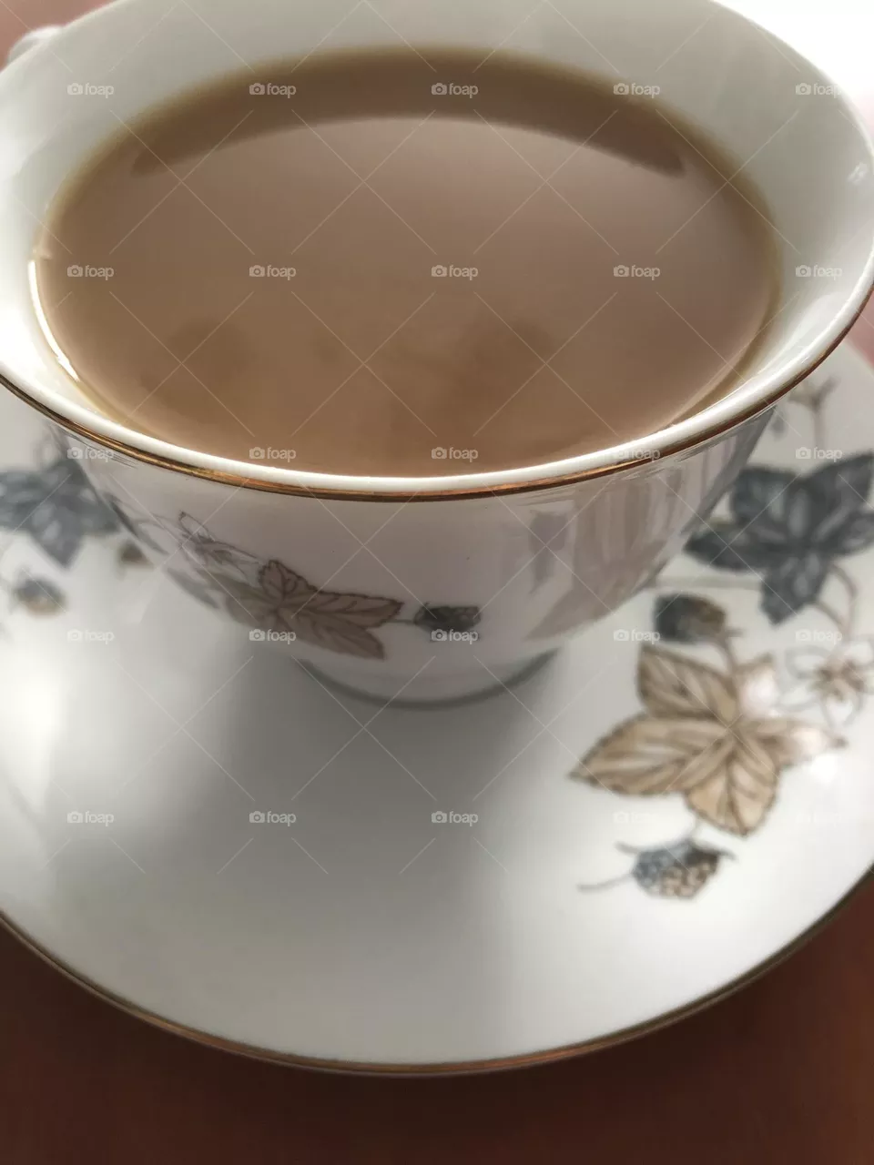 Tea time-milk tea in a classic tea cup with saucer