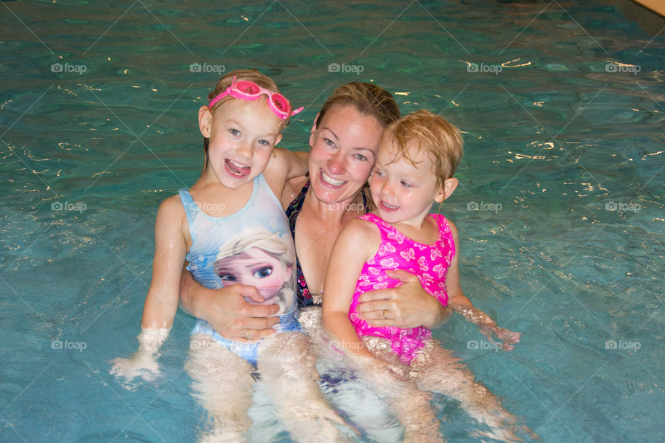 Mom with her two girls swimming in a pool at a hotel in Denmark.