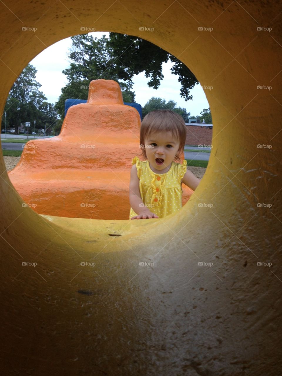 Surprised little girl looking at tunnel