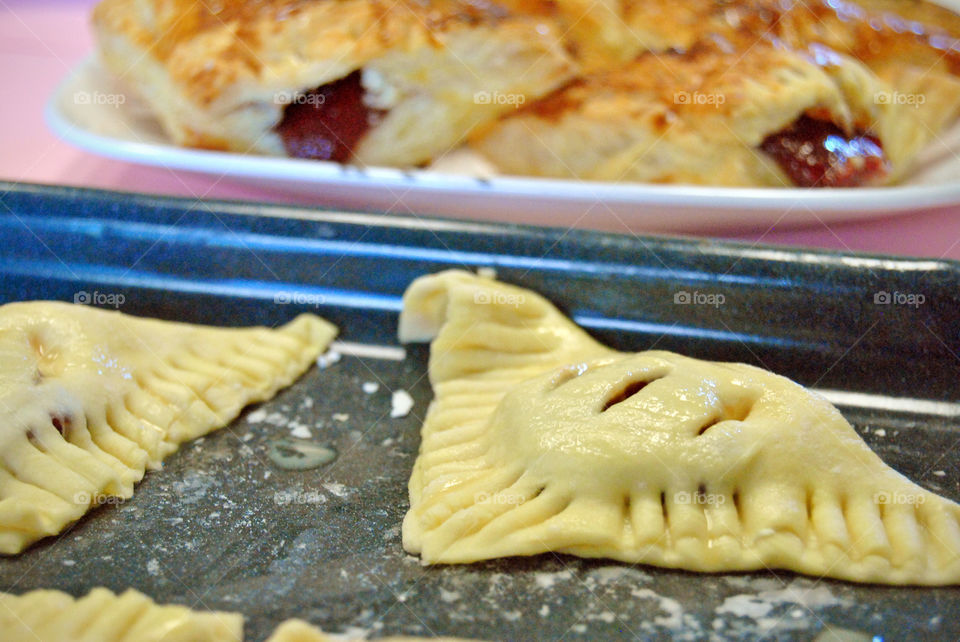 homemade glazed guava cheese strudel before baking, front focus, cooked or finished blurred at background