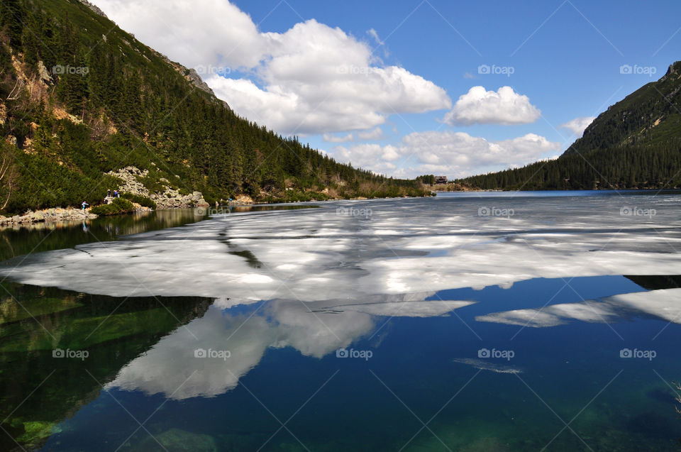 Mountain and forest reflecting on lake at poland