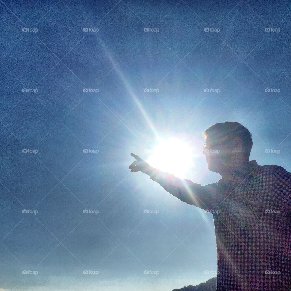 Man pointing at the sky