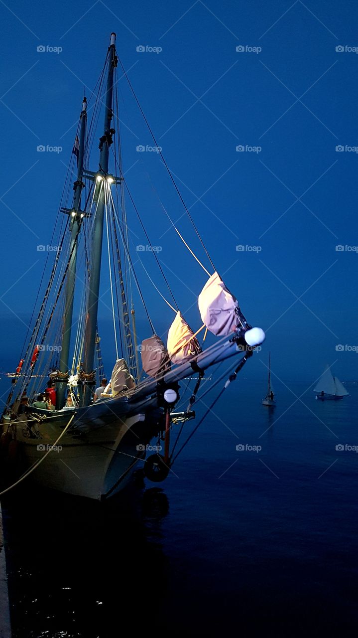 Spotlight on a sailboat in the night